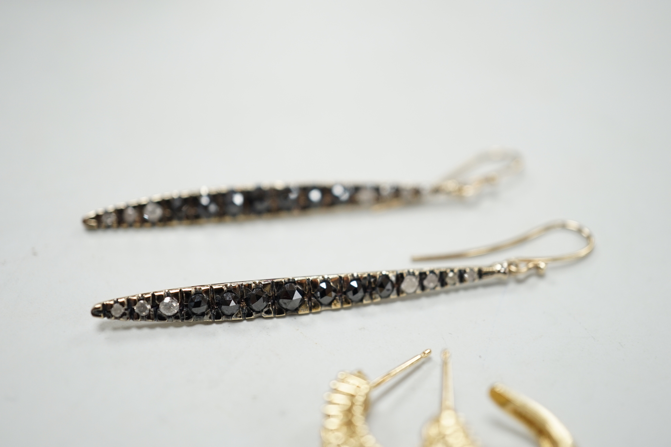 A modern pair of 14k yellow metal and two row diamond chip set half hoop earrings, 14mm, gross weight 4.6 grams, together with a modern pair of 18ct gold and two colour diamond set line earrings, 47mm, gross weight 5.3 g